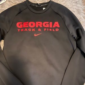 Black and red University of Georgia Track and Field sweatshirt.